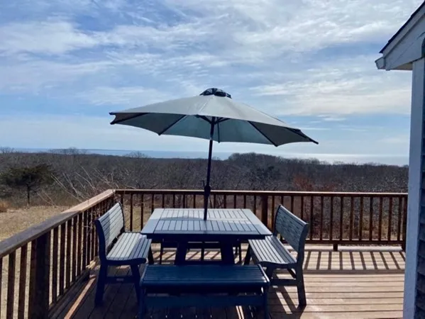 a roof deck with a table and chairs