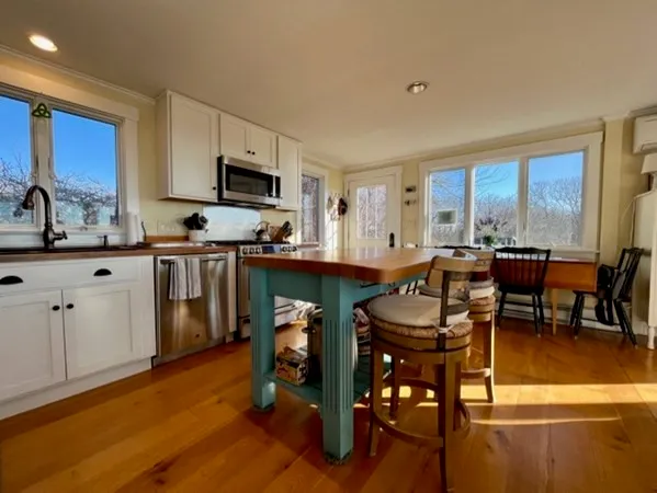 a view of kitchen with cabinets table and chairs