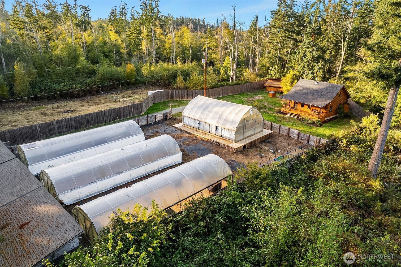 4 East Mountain View Road Camano Island, WA 98282 - Photo 3 of 26 a view of a patio with lawn chairs under an umbrella