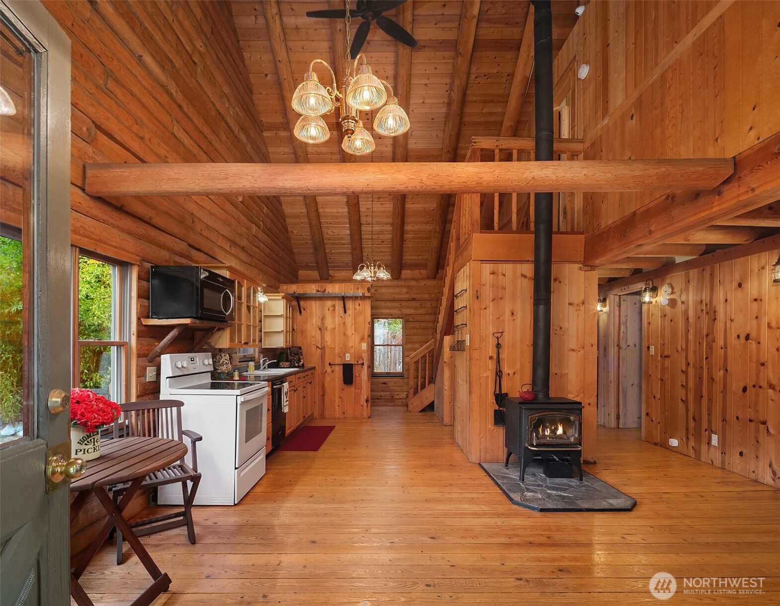 4 East Mountain View Road Camano Island, WA 98282 - Photo 5 of 26 a kitchen with stainless steel appliances kitchen island granite countertop a stove a refrigerator a sink a dining table and chairs with wooden floor