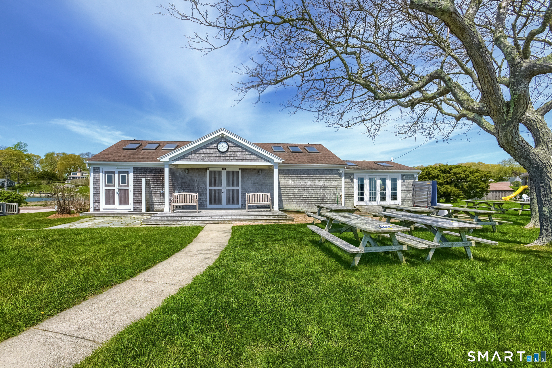 28 Money Point Road Stonington, CT 06355 - Photo 15 of 31 a front view of a house with a yard table and chairs
