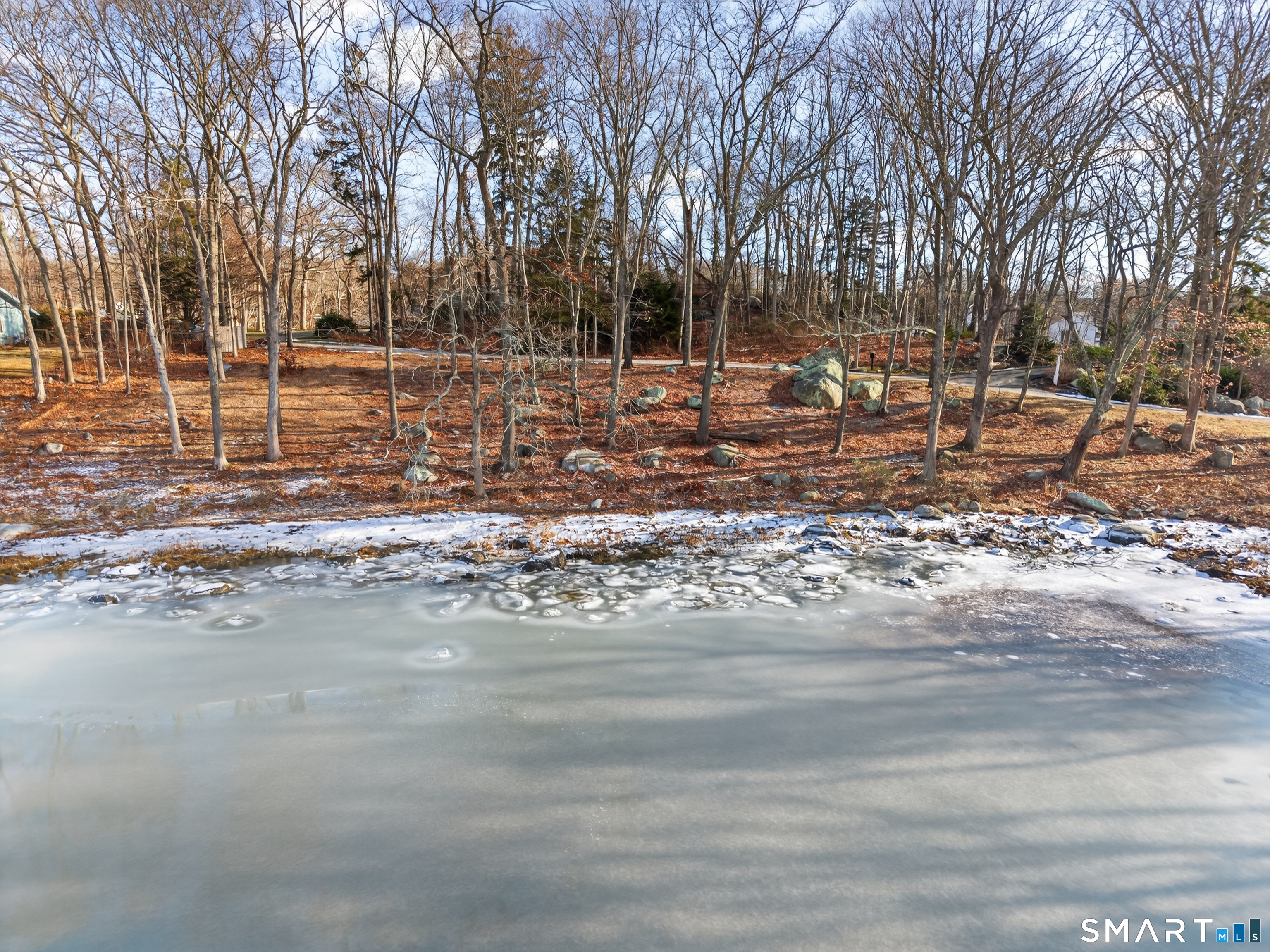 28 Money Point Road Stonington, CT 06355 - Photo 16 of 31 a backyard of a house with lots of trees
