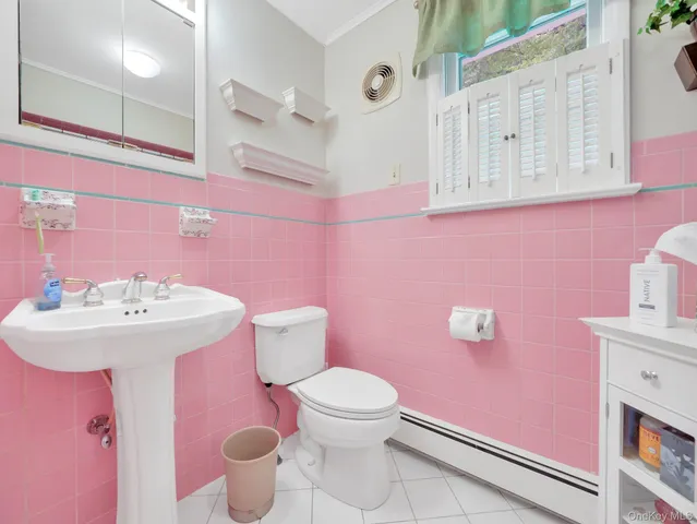 a bathroom with a sink mirror and toilet