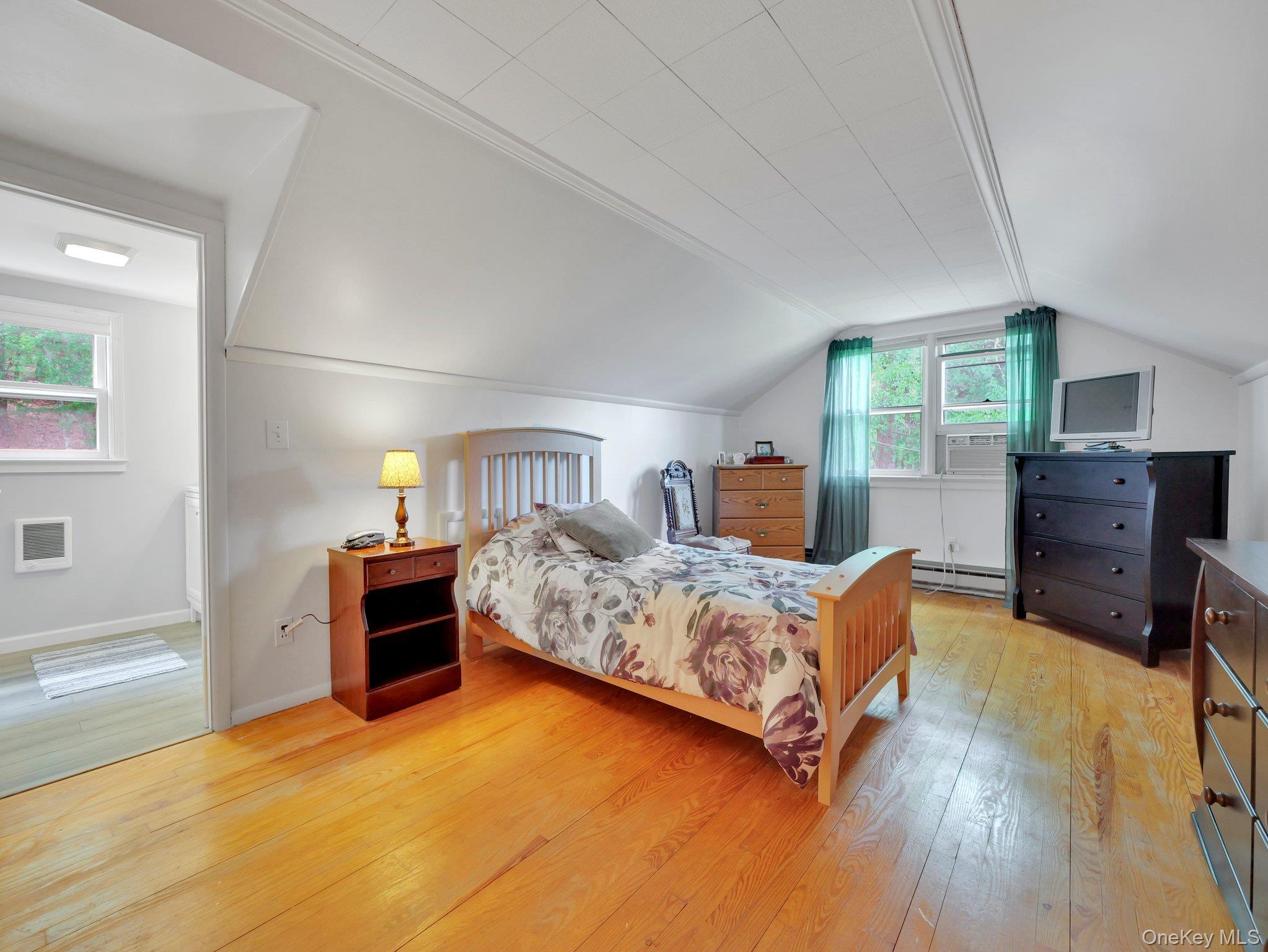 229 Eldred-Yulan Road Barryville, NY 12719 - Photo 14 of 34 a bedroom with furniture and a wooden floor