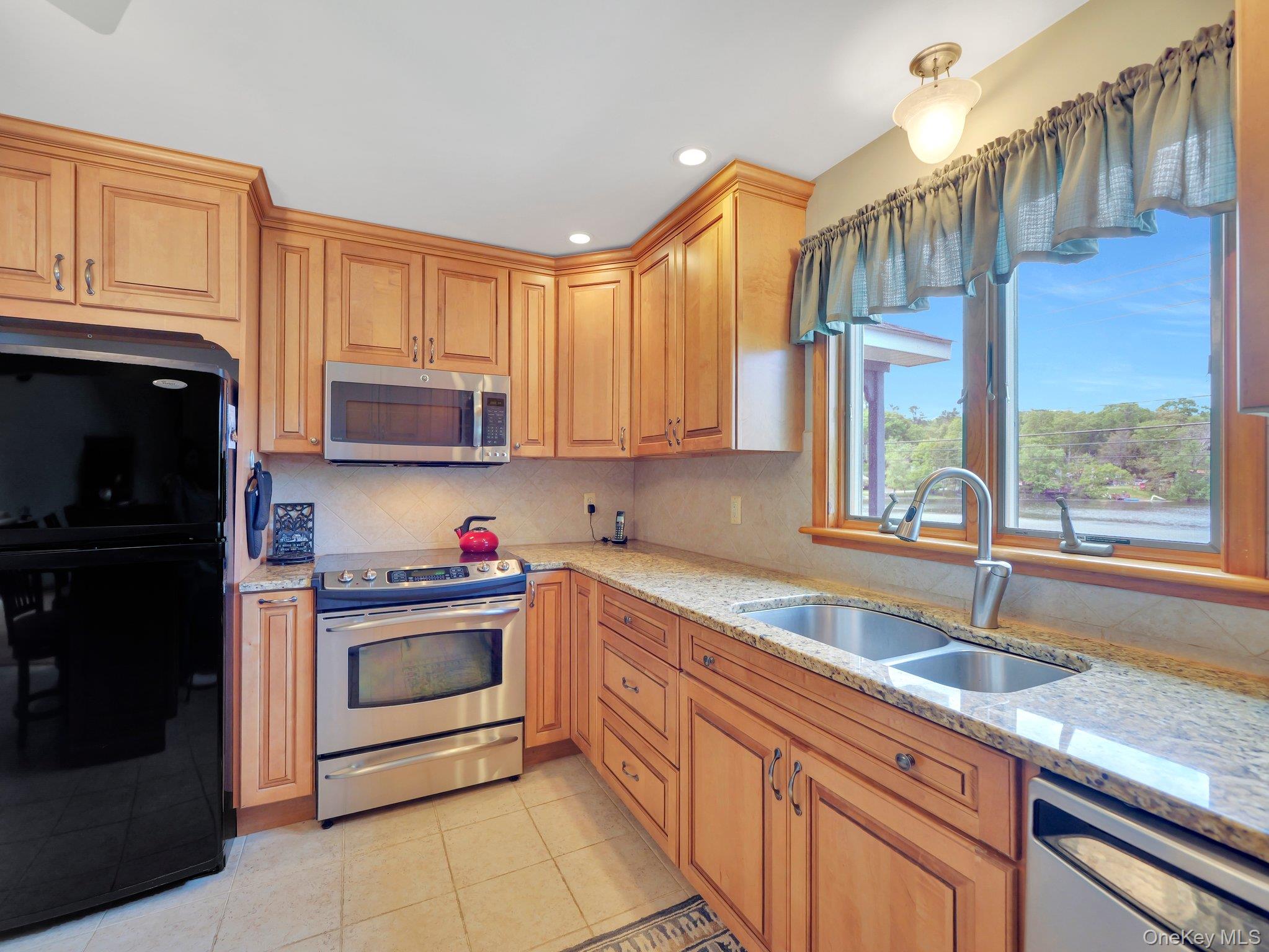 229 Eldred-Yulan Road Barryville, NY 12719 - Photo 22 of 34 a kitchen with granite countertop a sink stainless steel appliances and cabinets