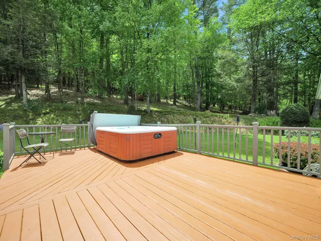 a view of a swimming pool with a patio and a yard