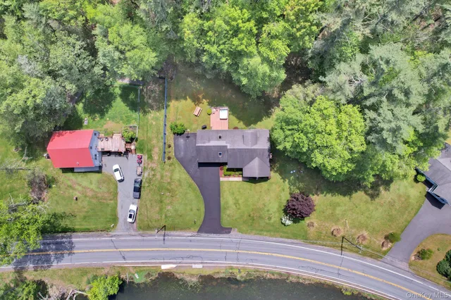 an aerial view of a house with a yard