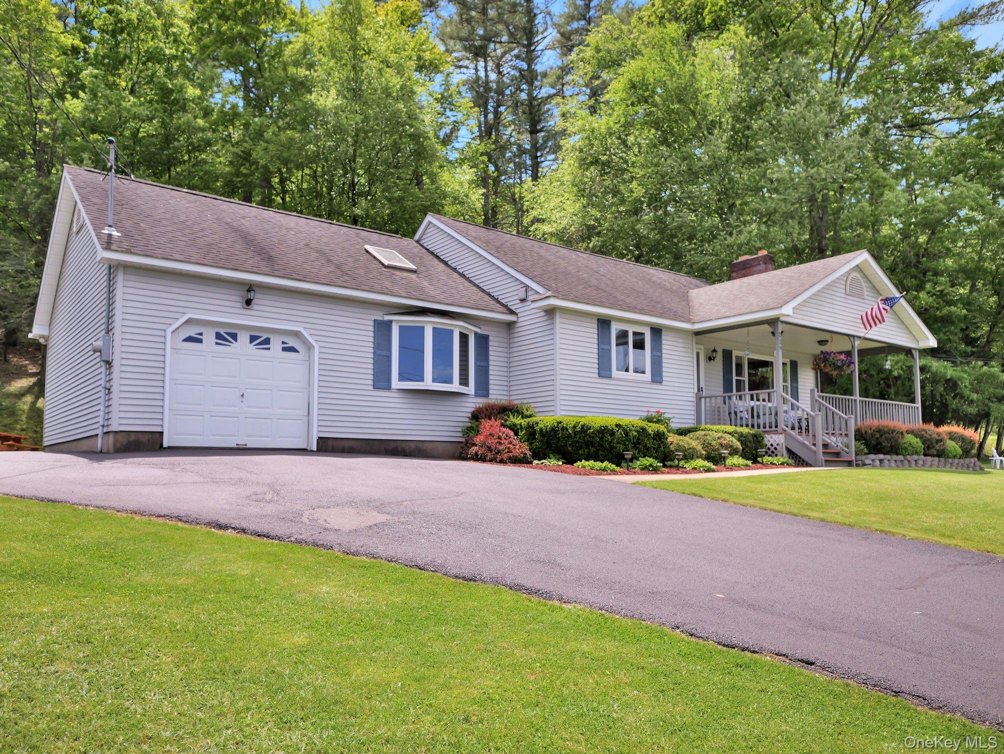 229 Eldred-Yulan Road Barryville, NY 12719 - Photo 33 of 34 a front view of a house with a yard and garage