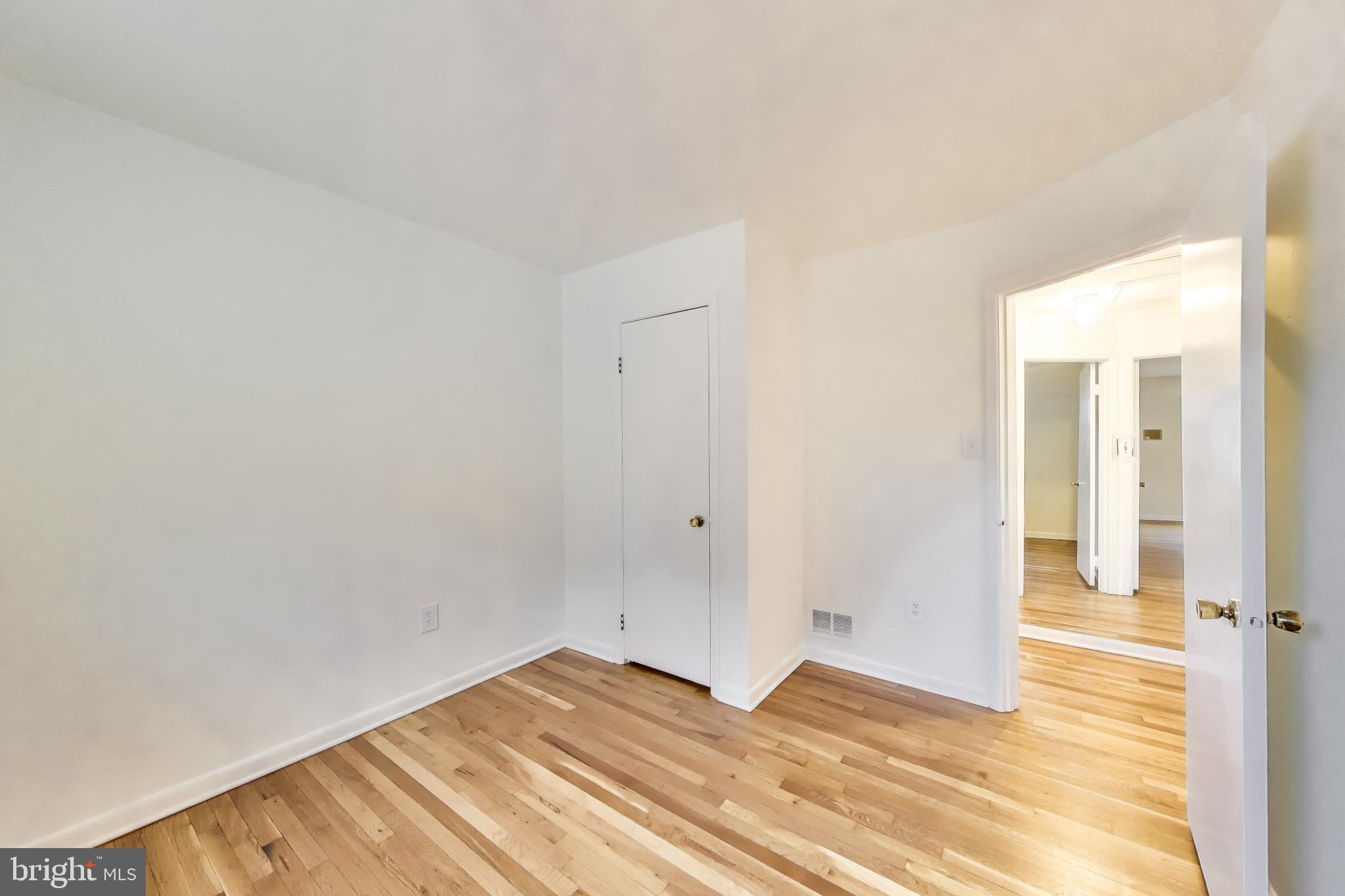 9233 Alcona Street Lanham, MD 20706 - Photo 23 of 43 a view of a room with wooden floor and a bathroom