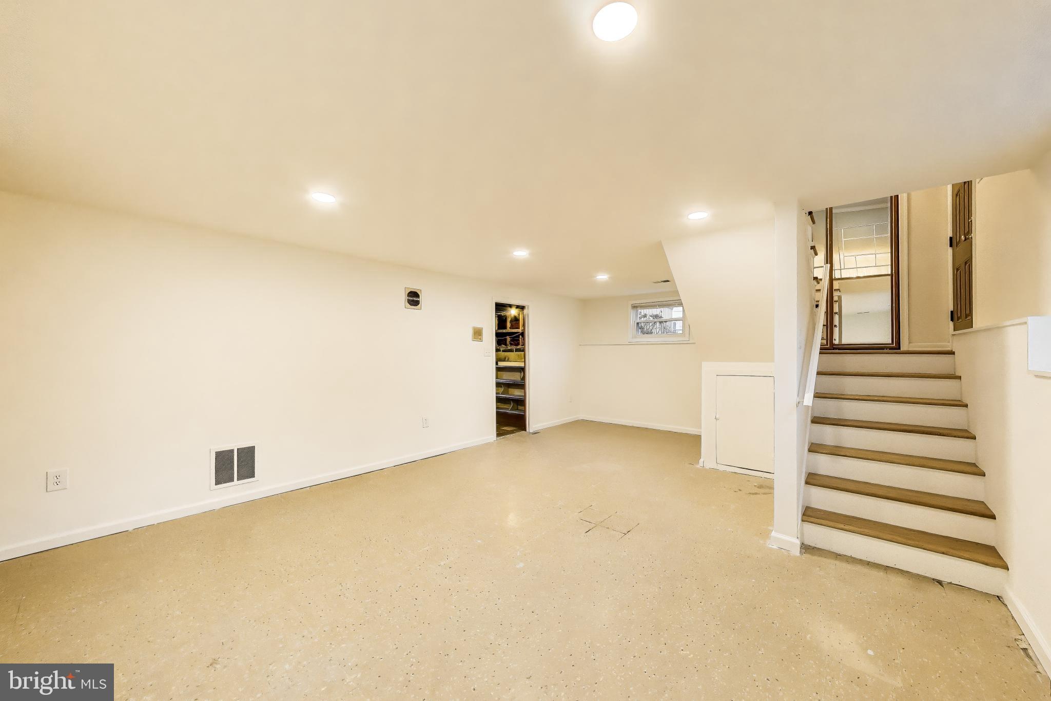 9233 Alcona Street Lanham, MD 20706 - Photo 26 of 43 a view of an empty room with wooden floor and entryway