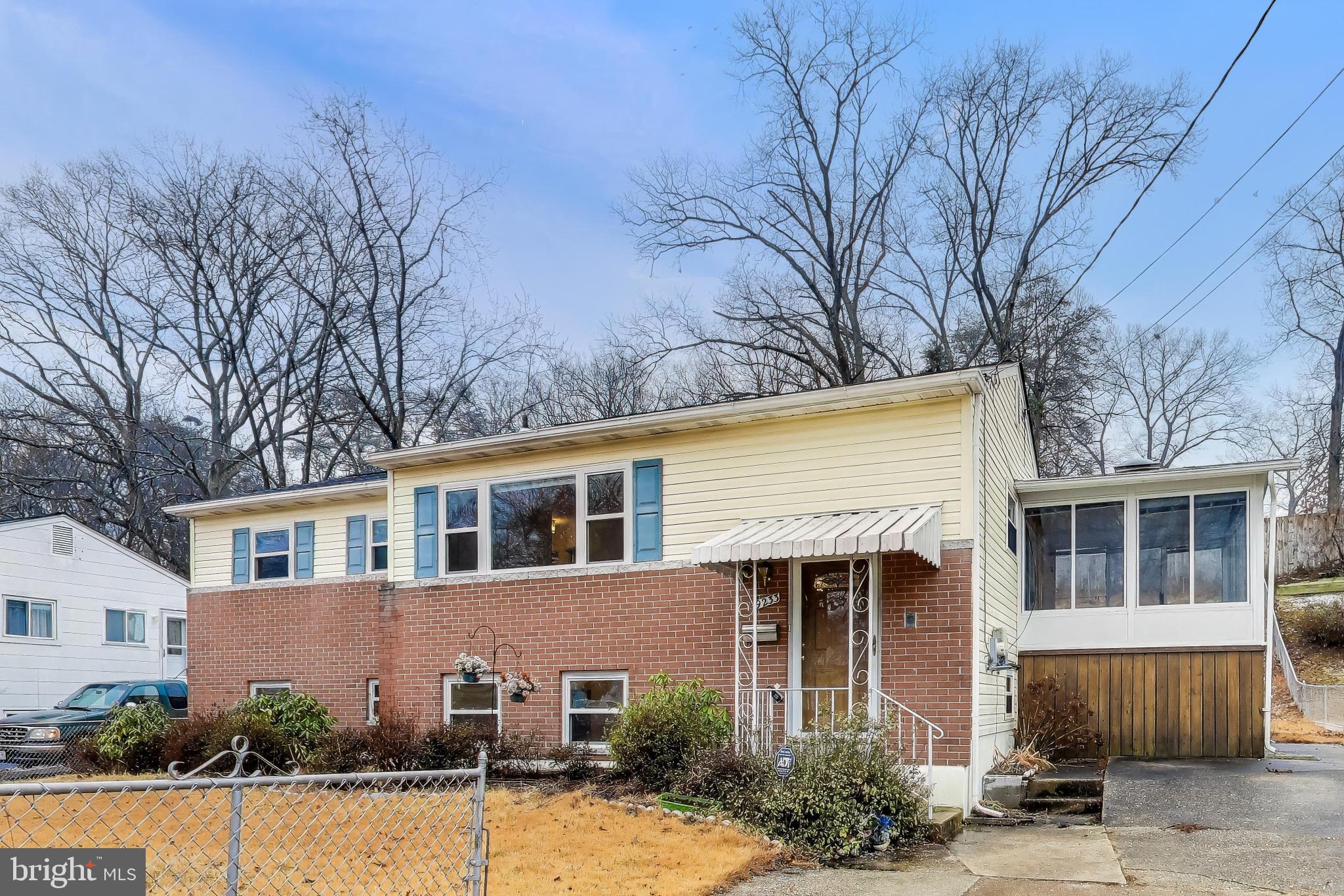 9233 Alcona Street Lanham, MD 20706 - Photo 3 of 43 a front view of a house with a yard
