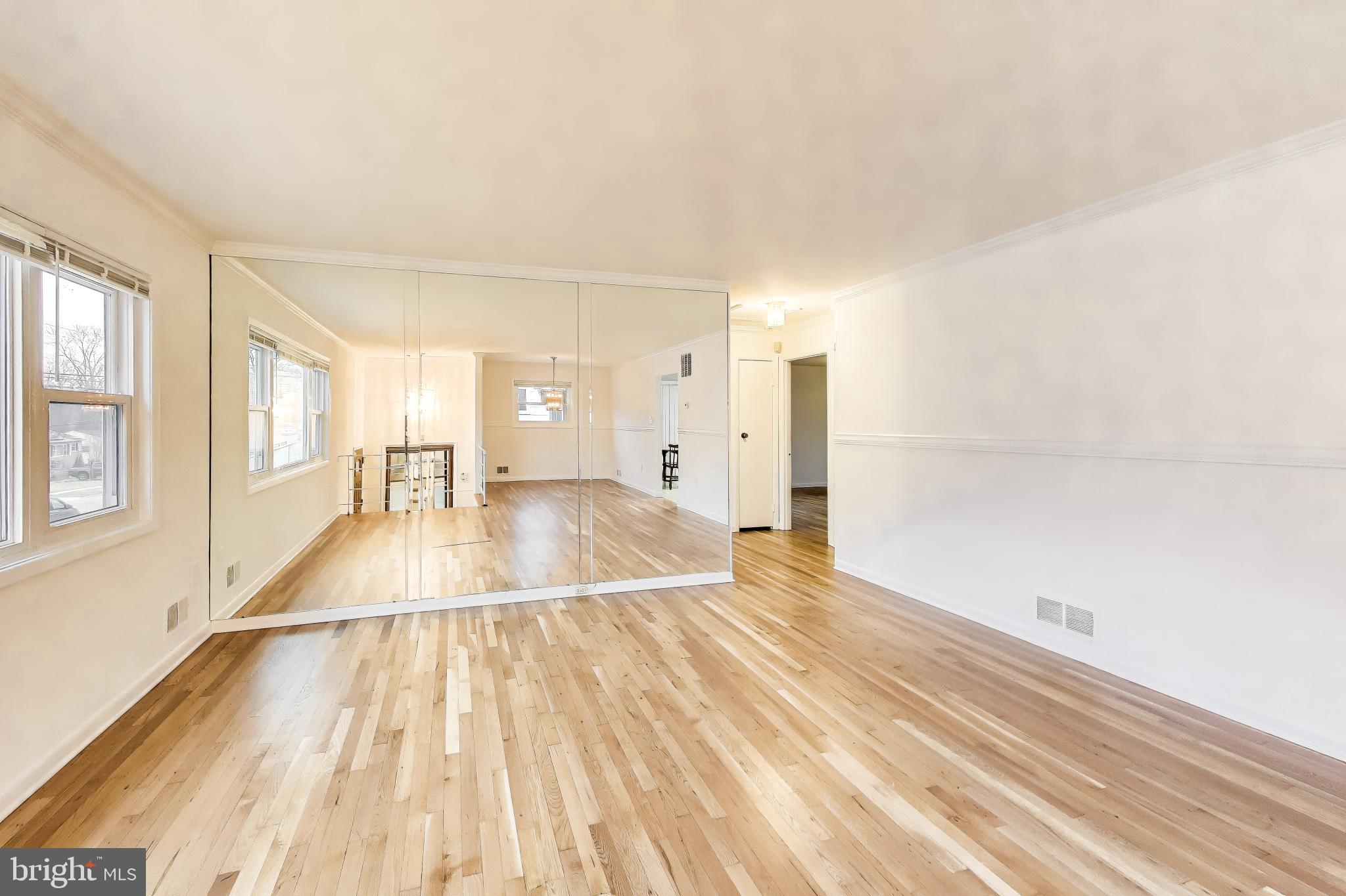 9233 Alcona Street Lanham, MD 20706 - Photo 4 of 43 a view of a room with wooden floor and a window