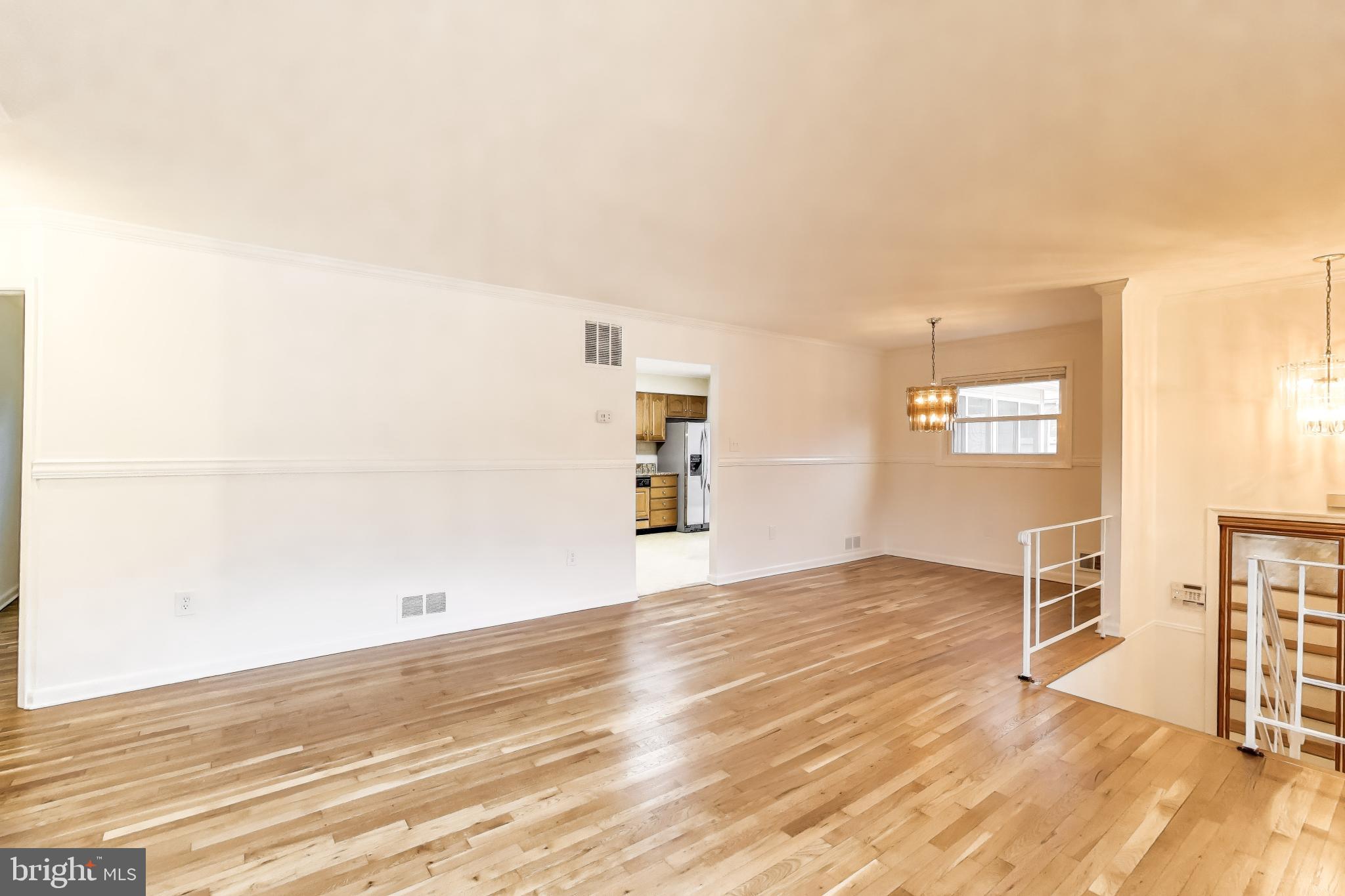9233 Alcona Street Lanham, MD 20706 - Photo 5 of 43 a view of an empty room with window and wooden floor