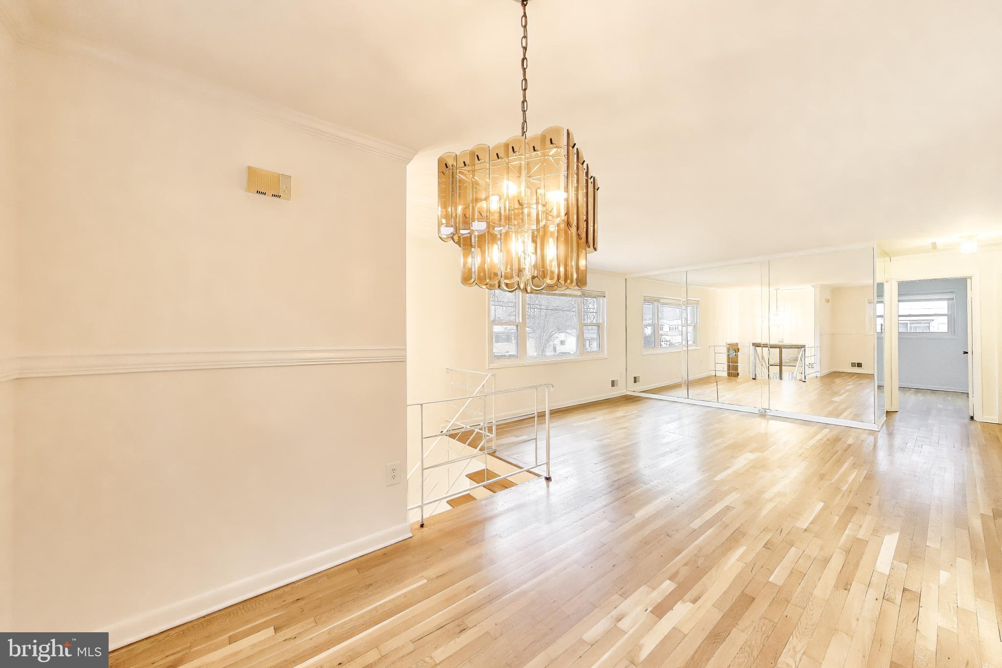 9233 Alcona Street Lanham, MD 20706 - Photo 9 of 43 a view of a room with wooden floor