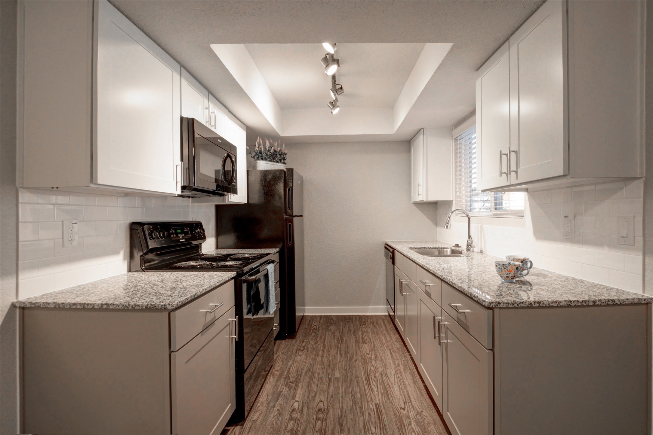 8787 Hammerly Boulevard, Unit 227 Houston, TX 77080 - Photo 1 of 40 a kitchen with stainless steel appliances granite countertop a sink stove microwave and refrigerator