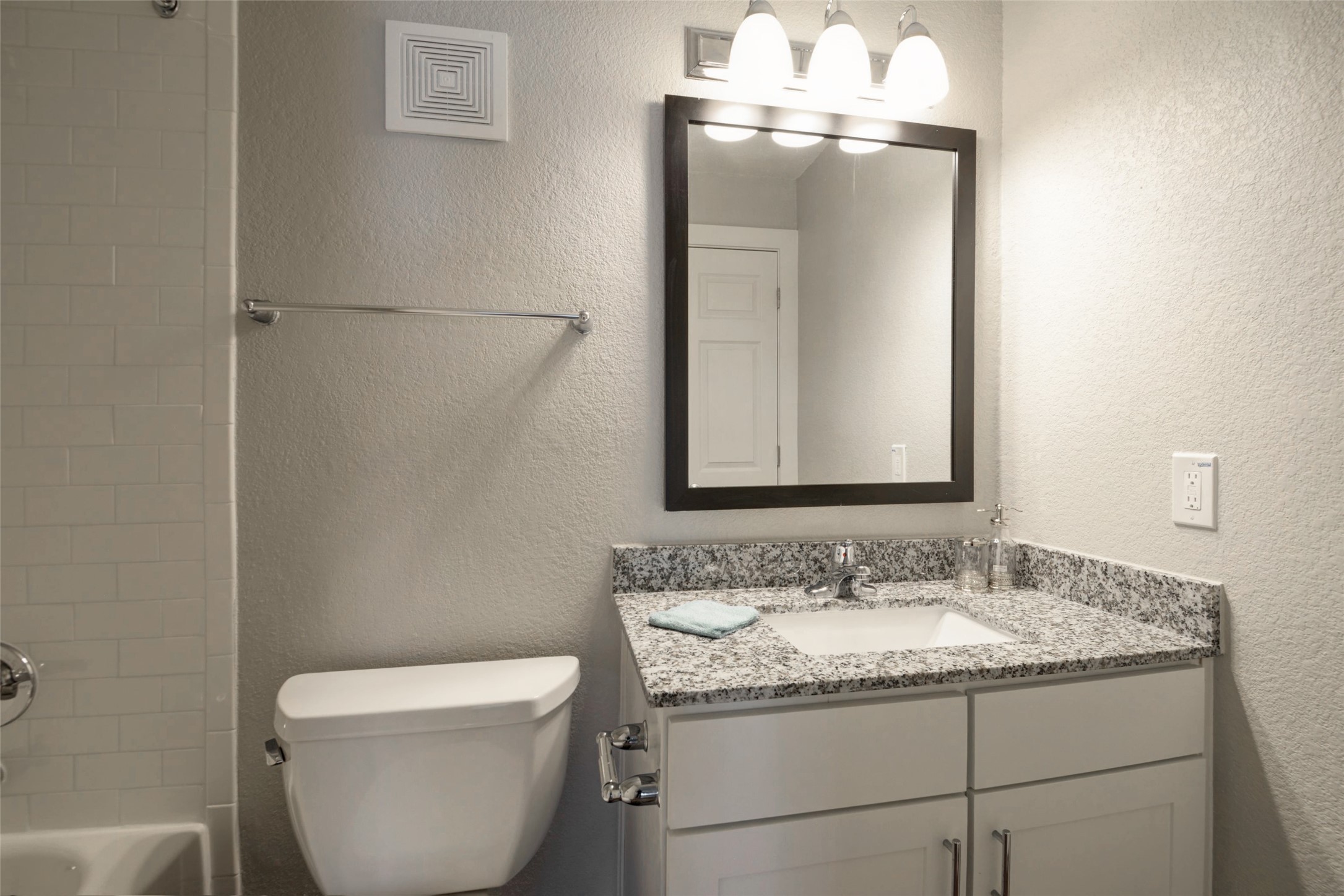 8787 Hammerly Boulevard, Unit 227 Houston, TX 77080 - Photo 5 of 40 a bathroom with a granite countertop sink toilet and mirror