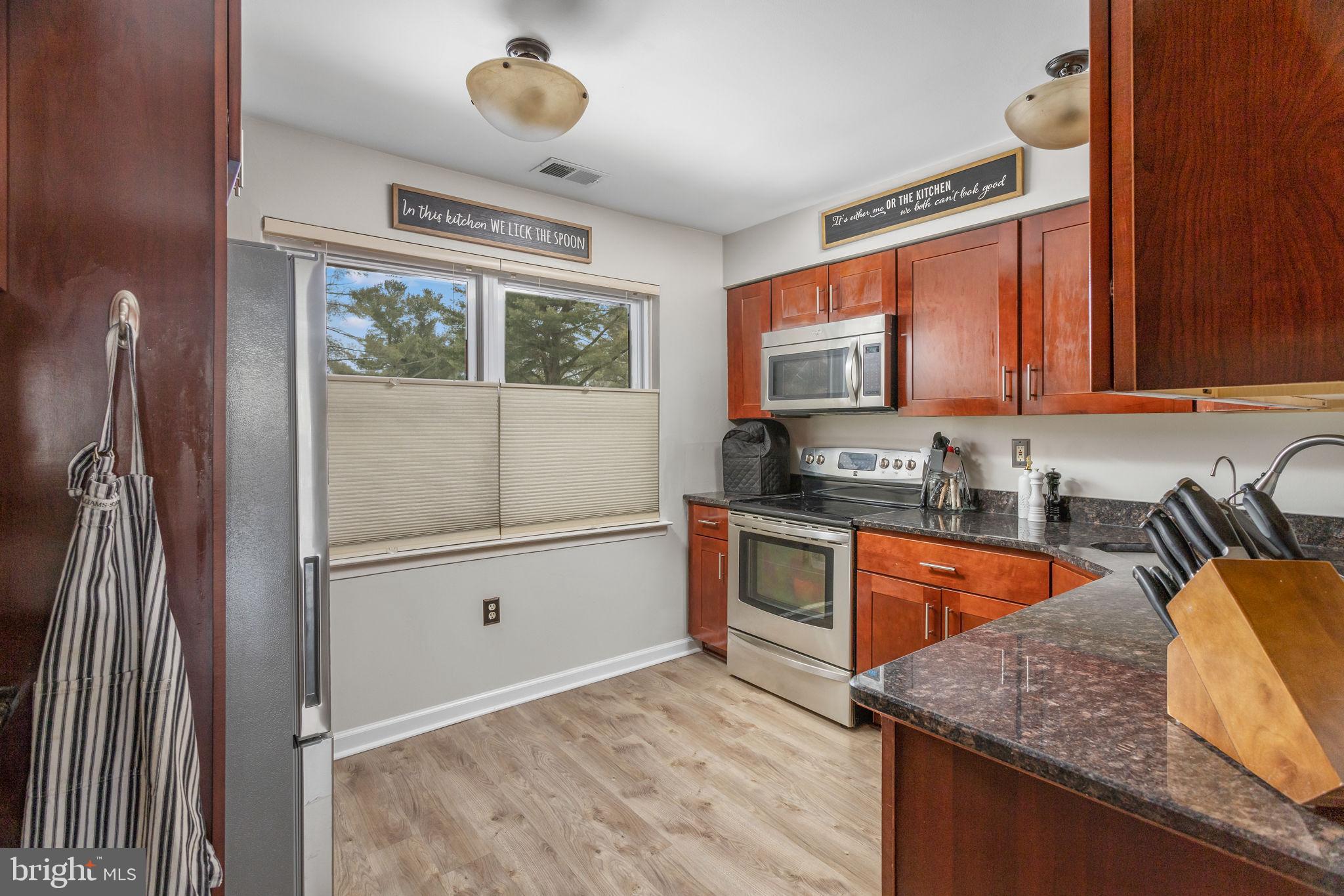1306 Silver Court Hamilton, NJ 08690 - Photo 12 of 28 a kitchen with stainless steel appliances granite countertop a sink stove and refrigerator