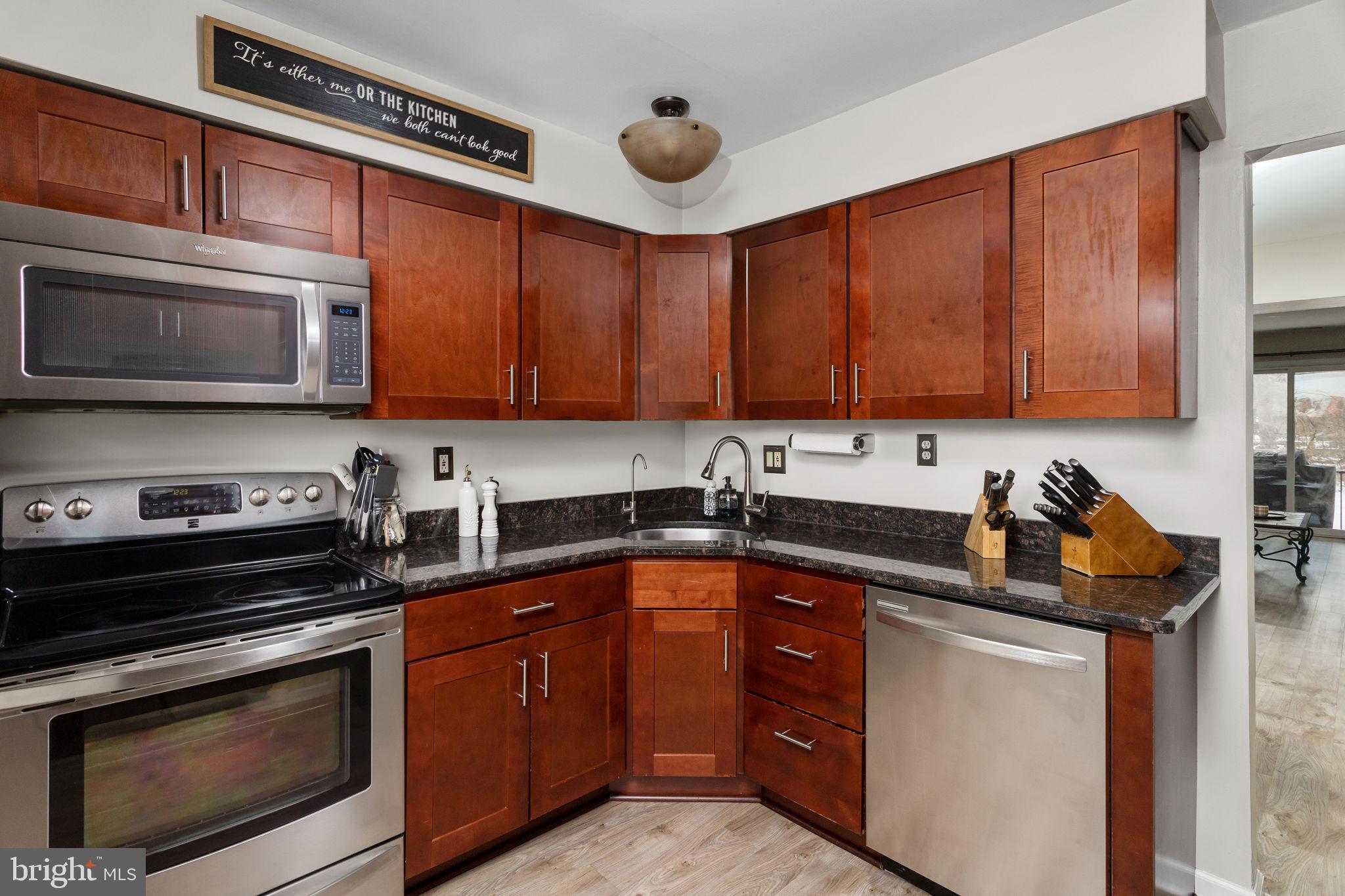 1306 Silver Court Hamilton, NJ 08690 - Photo 13 of 28 a kitchen with stainless steel appliances a stove a sink cabinets and a microwave