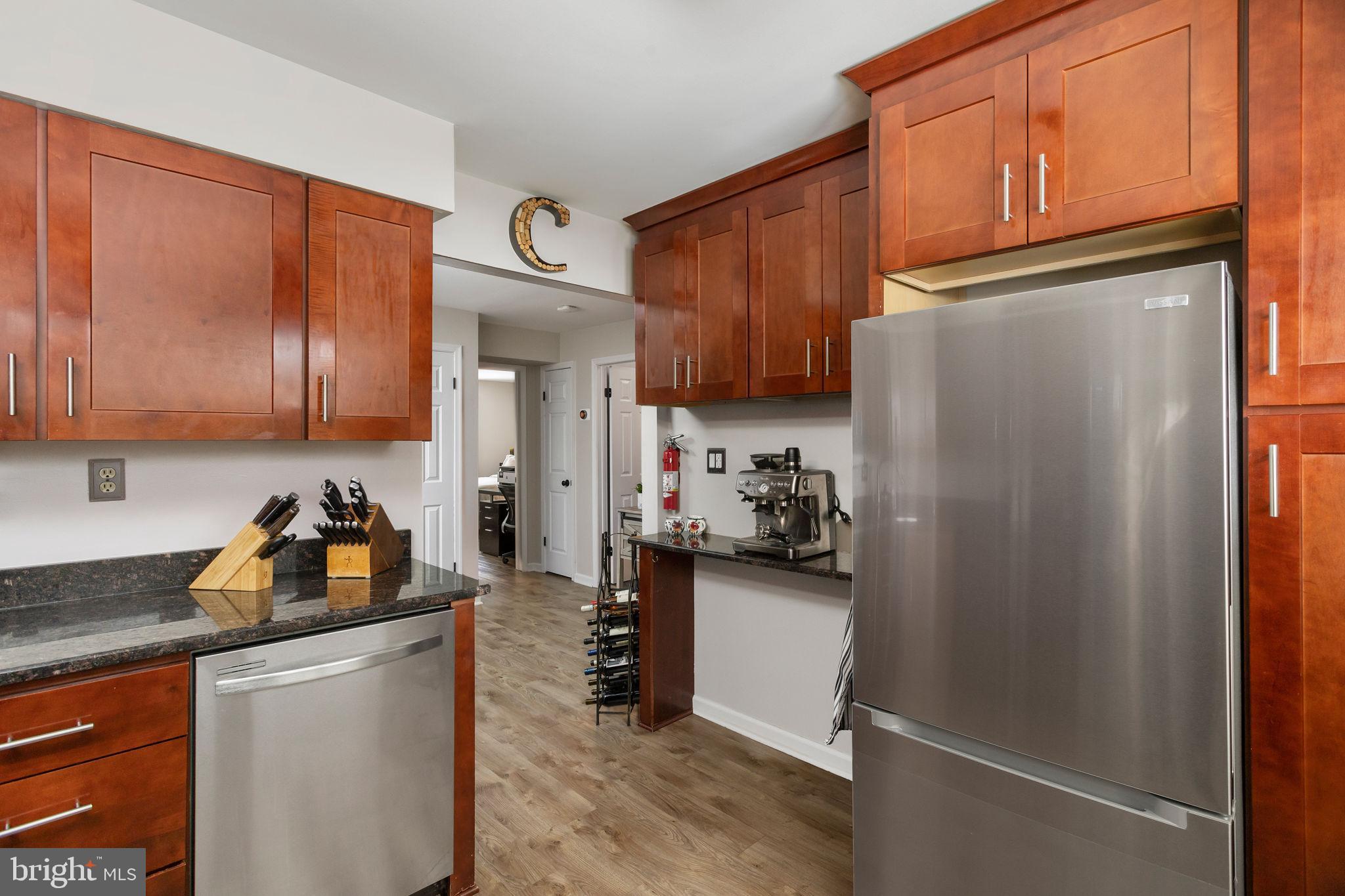 1306 Silver Court Hamilton, NJ 08690 - Photo 14 of 28 a kitchen with a refrigerator and cabinets