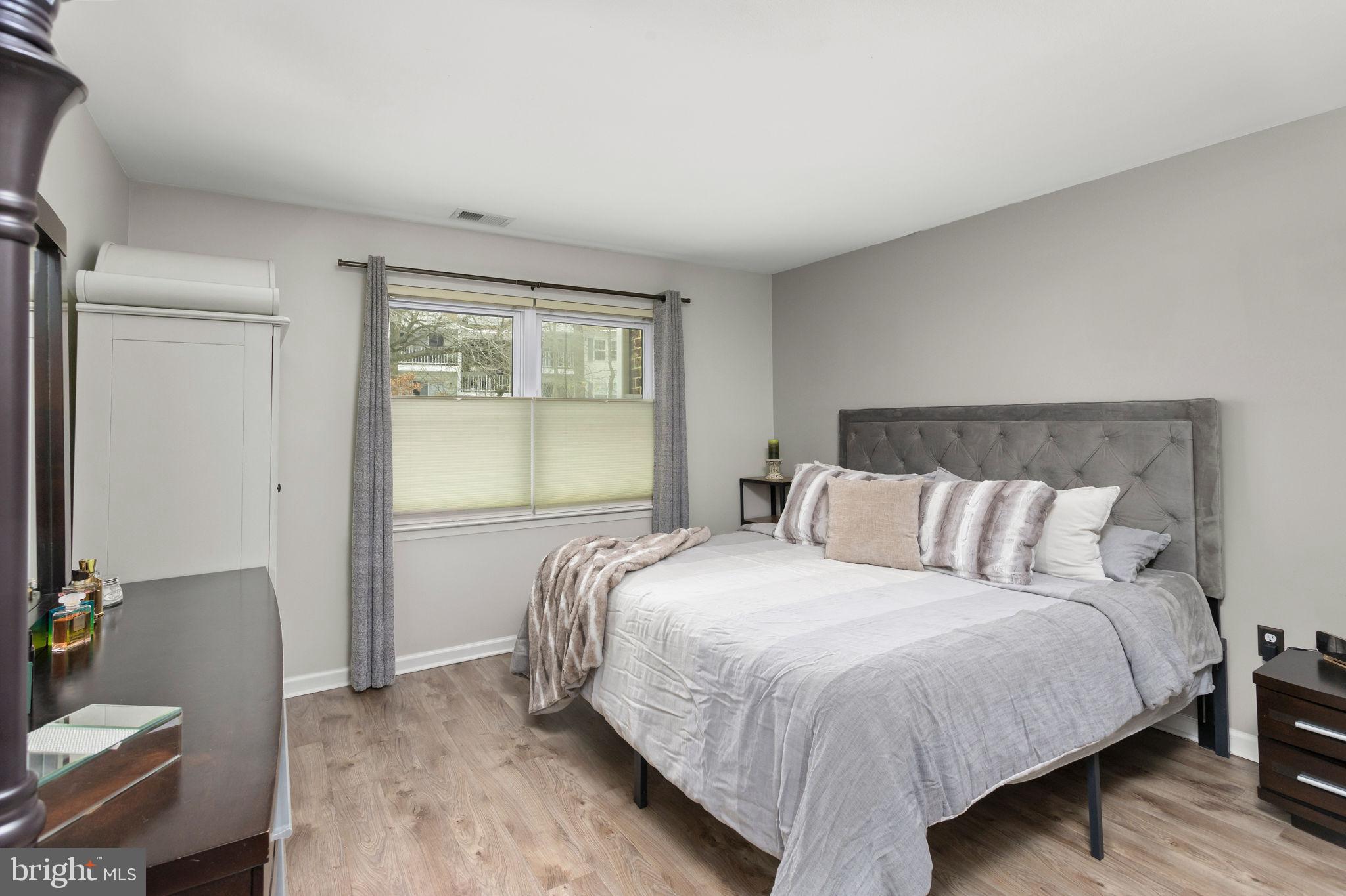 1306 Silver Court Hamilton, NJ 08690 - Photo 17 of 28 a bed sitting in a bedroom next to a window