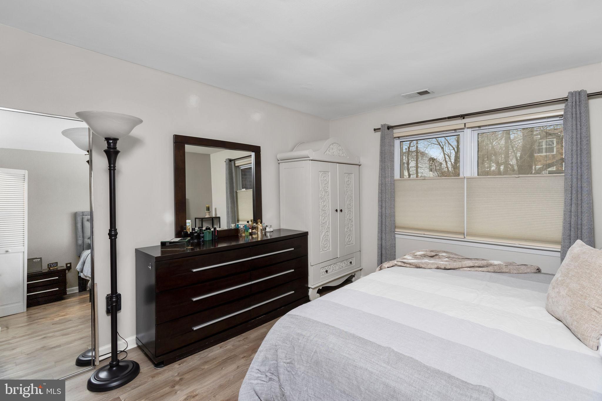 1306 Silver Court Hamilton, NJ 08690 - Photo 18 of 28 a bedroom with a bed and a dresser