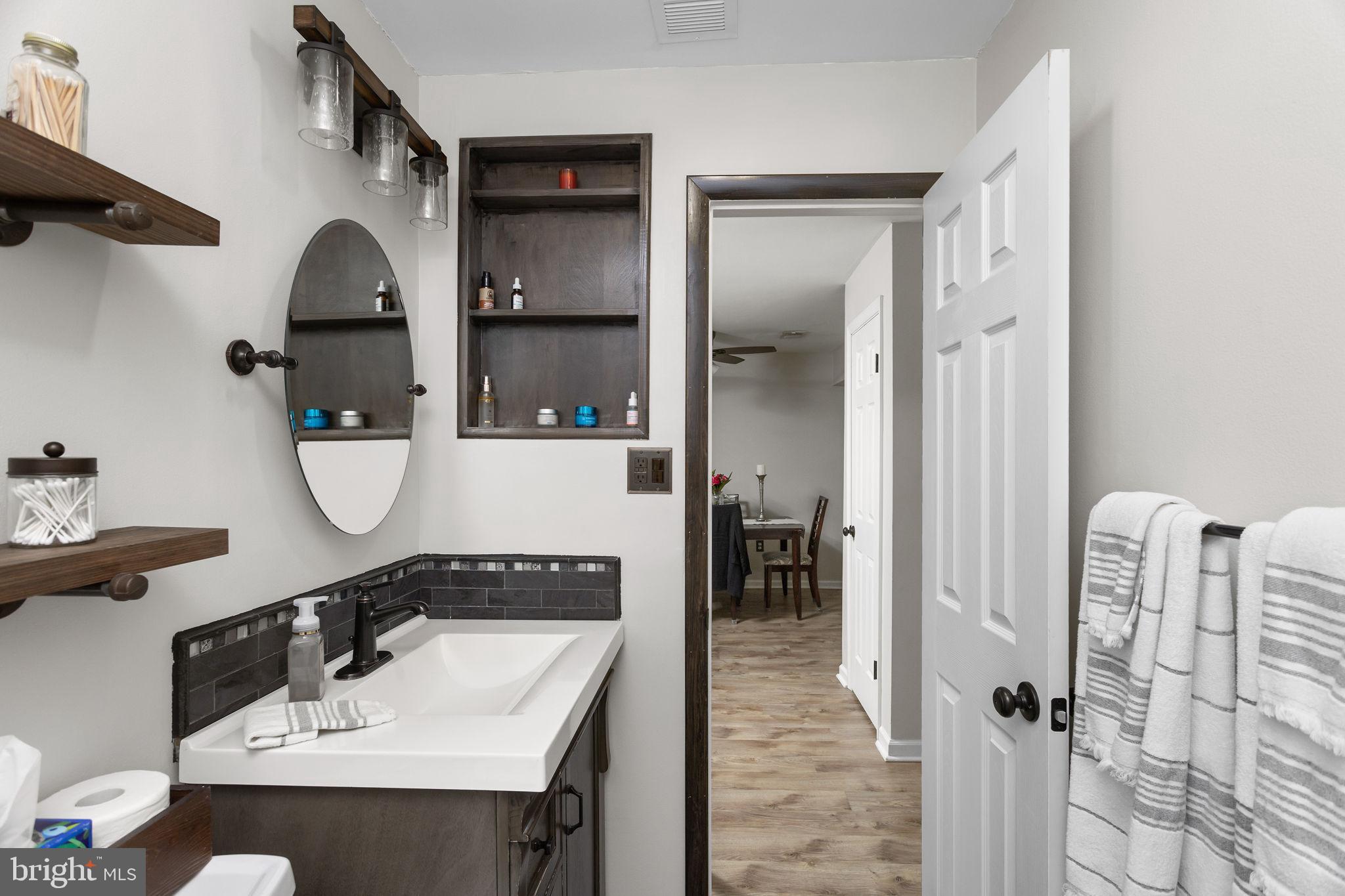 1306 Silver Court Hamilton, NJ 08690 - Photo 21 of 28 a bathroom with a sink and mirror