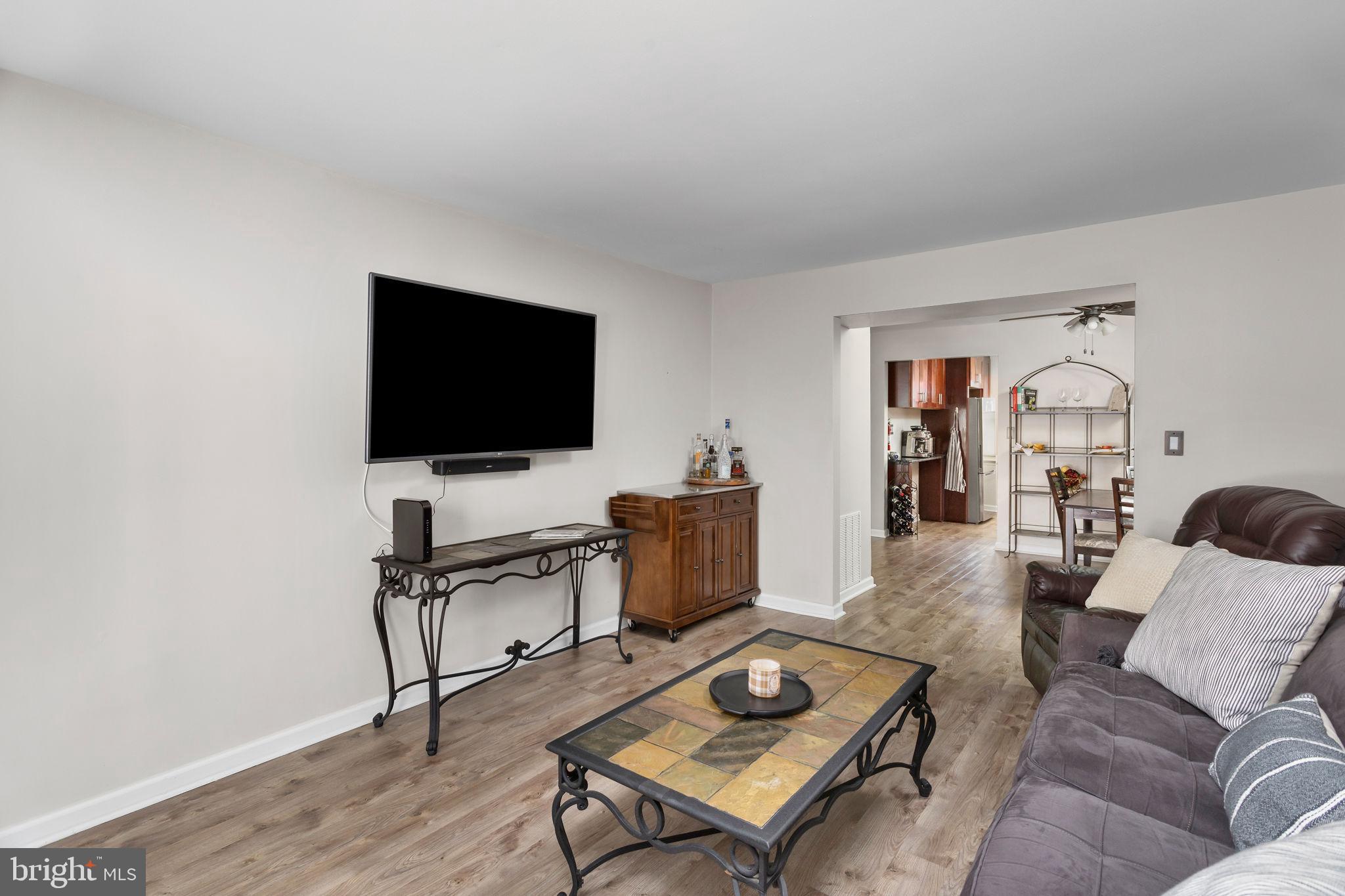 1306 Silver Court Hamilton, NJ 08690 - Photo 9 of 28 a living room with furniture and a flat screen tv