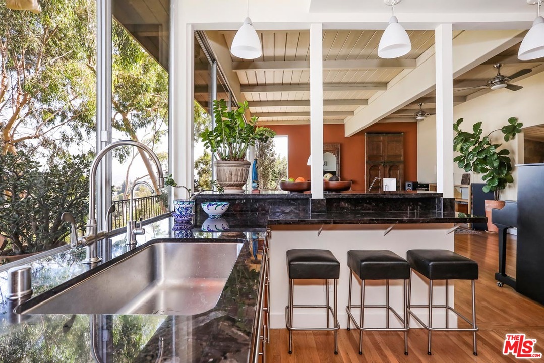 2730 Ivan Court Los Angeles, CA 90039 - Photo 16 of 38 a kitchen with a table chairs stove and cabinets
