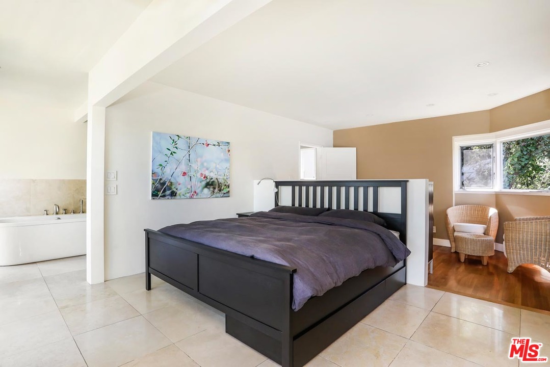 2730 Ivan Court Los Angeles, CA 90039 - Photo 17 of 38 a spacious bedroom with a bed and a painting on the wall