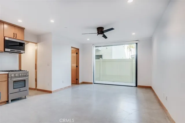 a view of a kitchen with a sink and a refrigerator