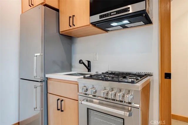 a stove top oven sitting inside of a kitchen
