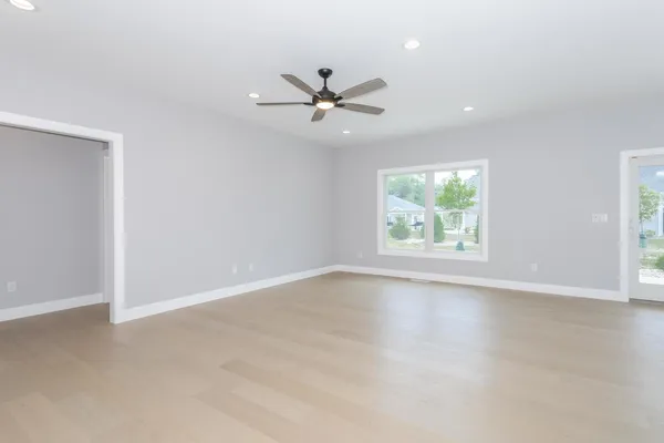 a view of an empty room with kitchen appliances and a window