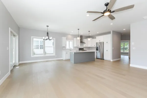 an empty room with a window and a fan