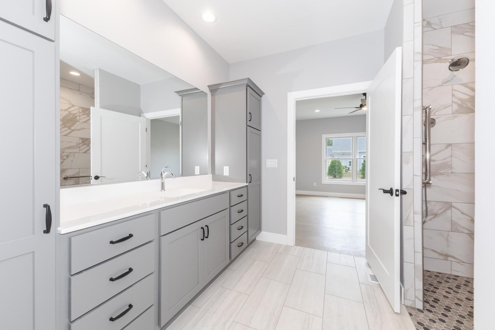 520 South 6th Street Fairbury, IL 61739 - Photo 33 of 42 a spacious bathroom with a double vanity sink a large mirror and a shower