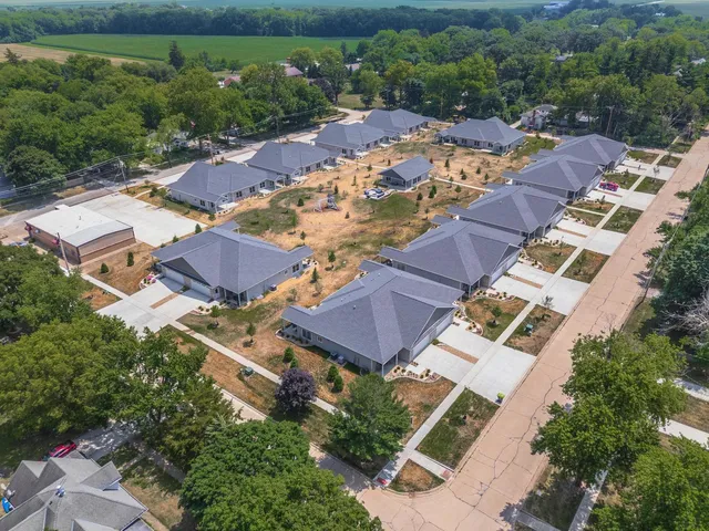 an aerial view of residential houses and car parked