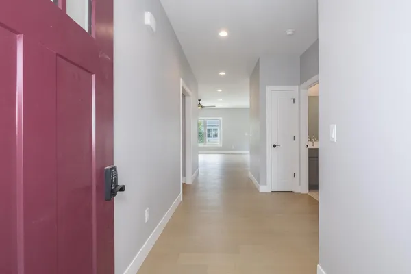 a view of a hallway with wooden shelves