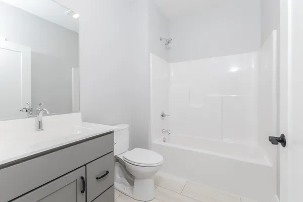 a view of a hallway with wooden floor and closet area