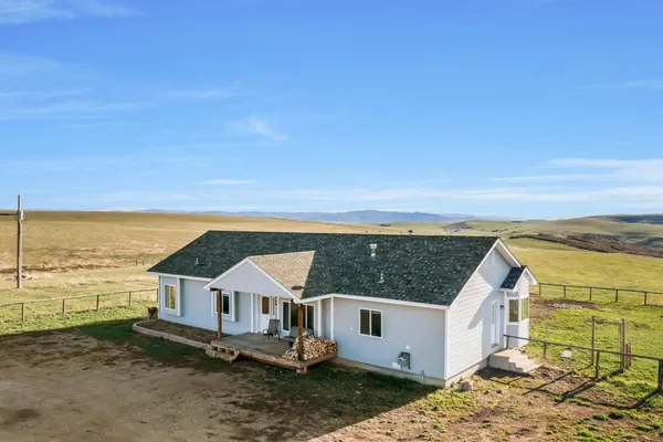 an aerial view of house with ocean view