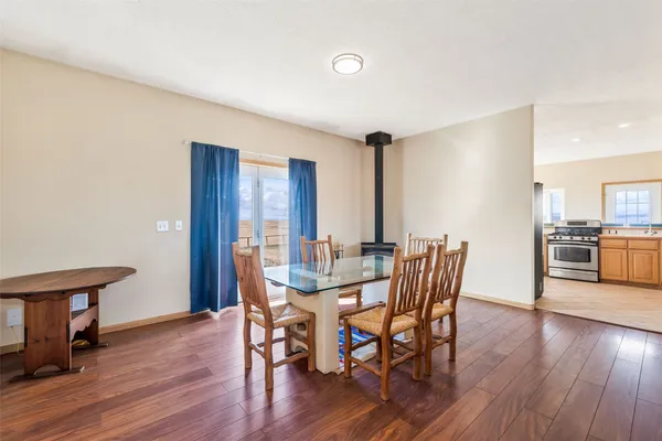 a view of a dining room with furniture and wooden floor