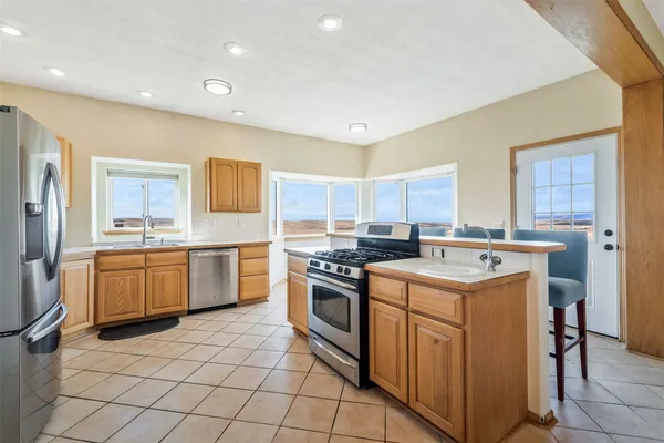 a kitchen with a stove sink and cabinets
