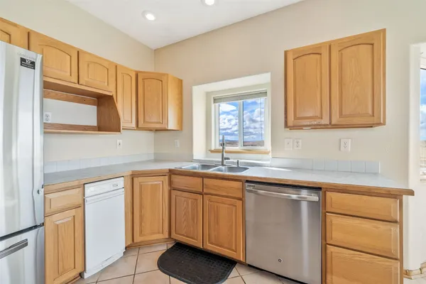 a kitchen with white cabinets and sink