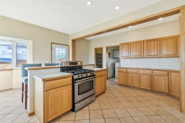a kitchen with a stove top oven sink and cabinets