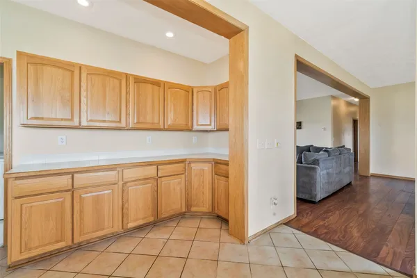 a kitchen with cabinets and wooden floor