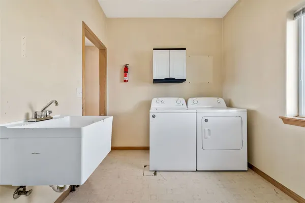 a view of a patio with lawn chairs floor to ceiling window and garden
