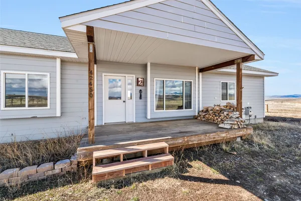 a backyard of a house with outdoor seating