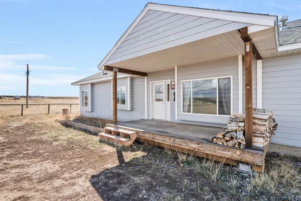 a view of a house with a backyard and sitting area