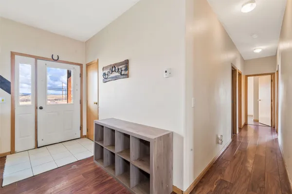 a view of a hallway with wooden floor