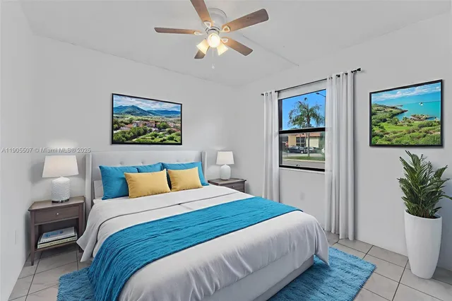 a bedroom with a bed and a painting on the wall