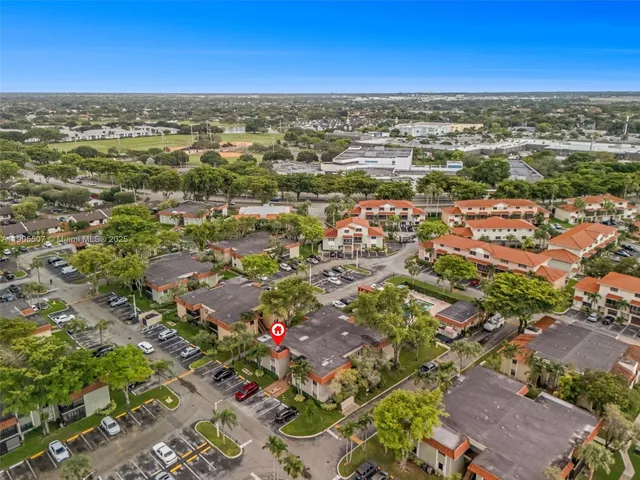 an aerial view of residential houses with city view