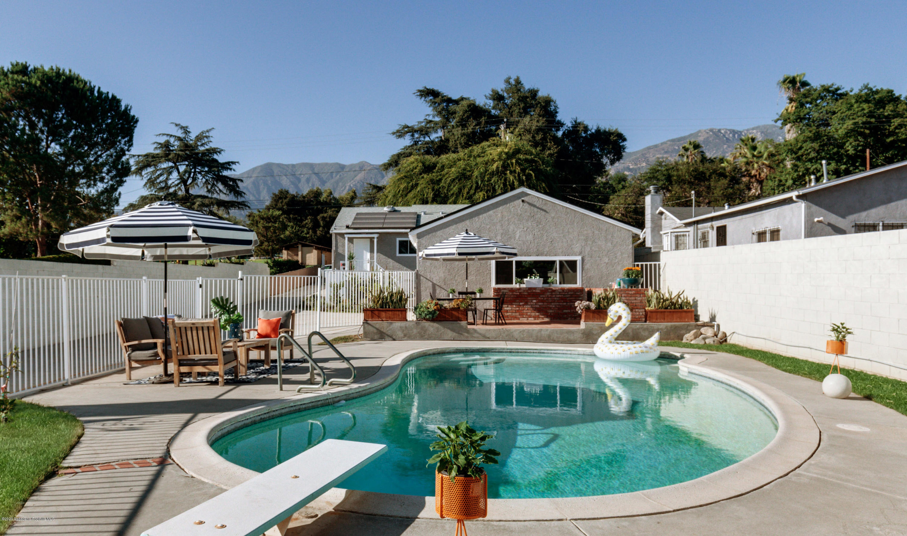 an outdoor space with the patio and swimming pool